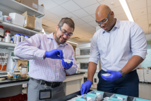 Mark Blenner and Kevin Solomon conduct research in a laboratory at the University of Delaware.