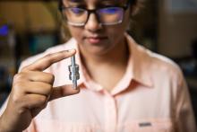 Nurun Nahar Lata holds a component of the Size and Time-Resolved Aerosol Collector