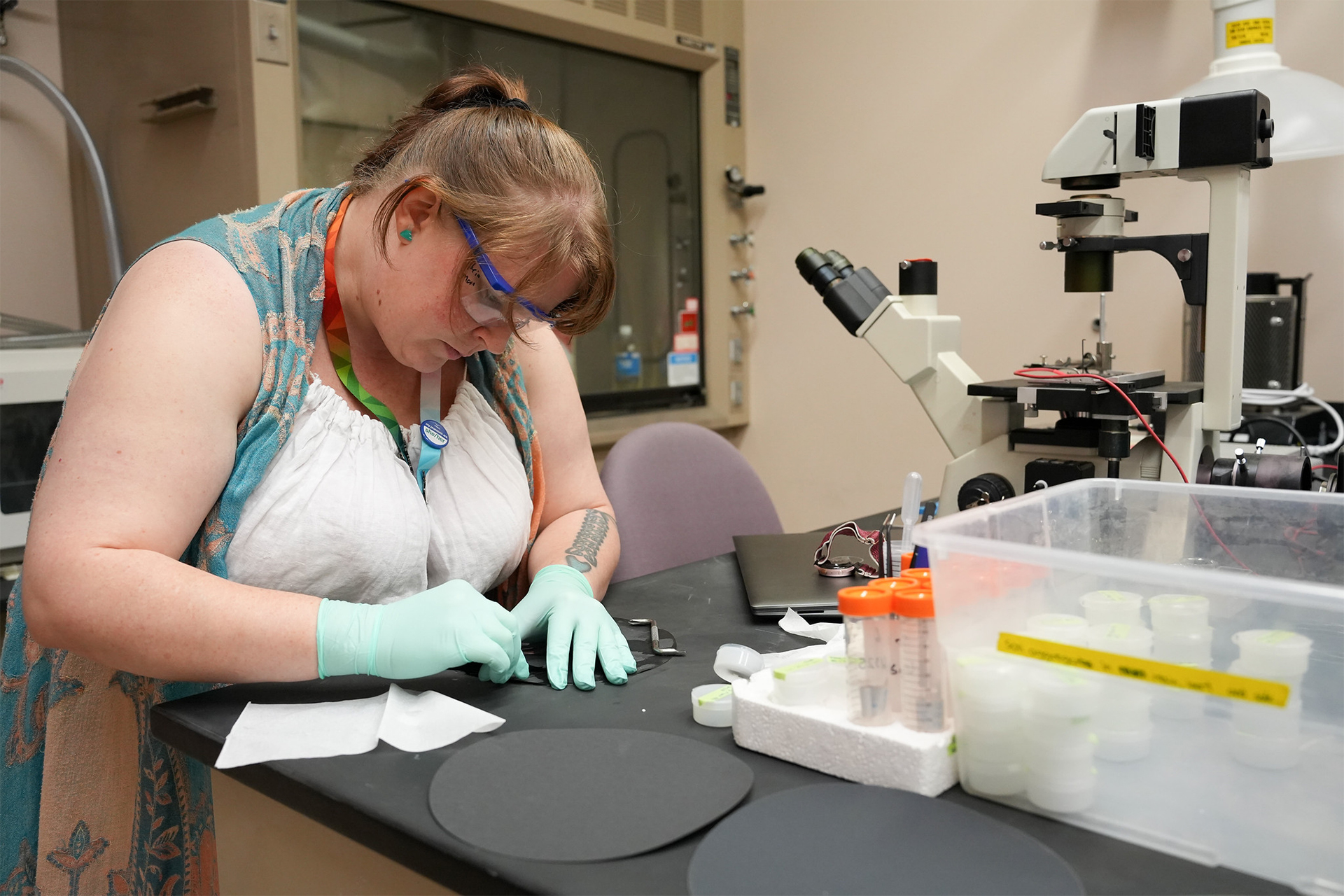 Photo of researcher Theia Moon intently working at a laboratory station.