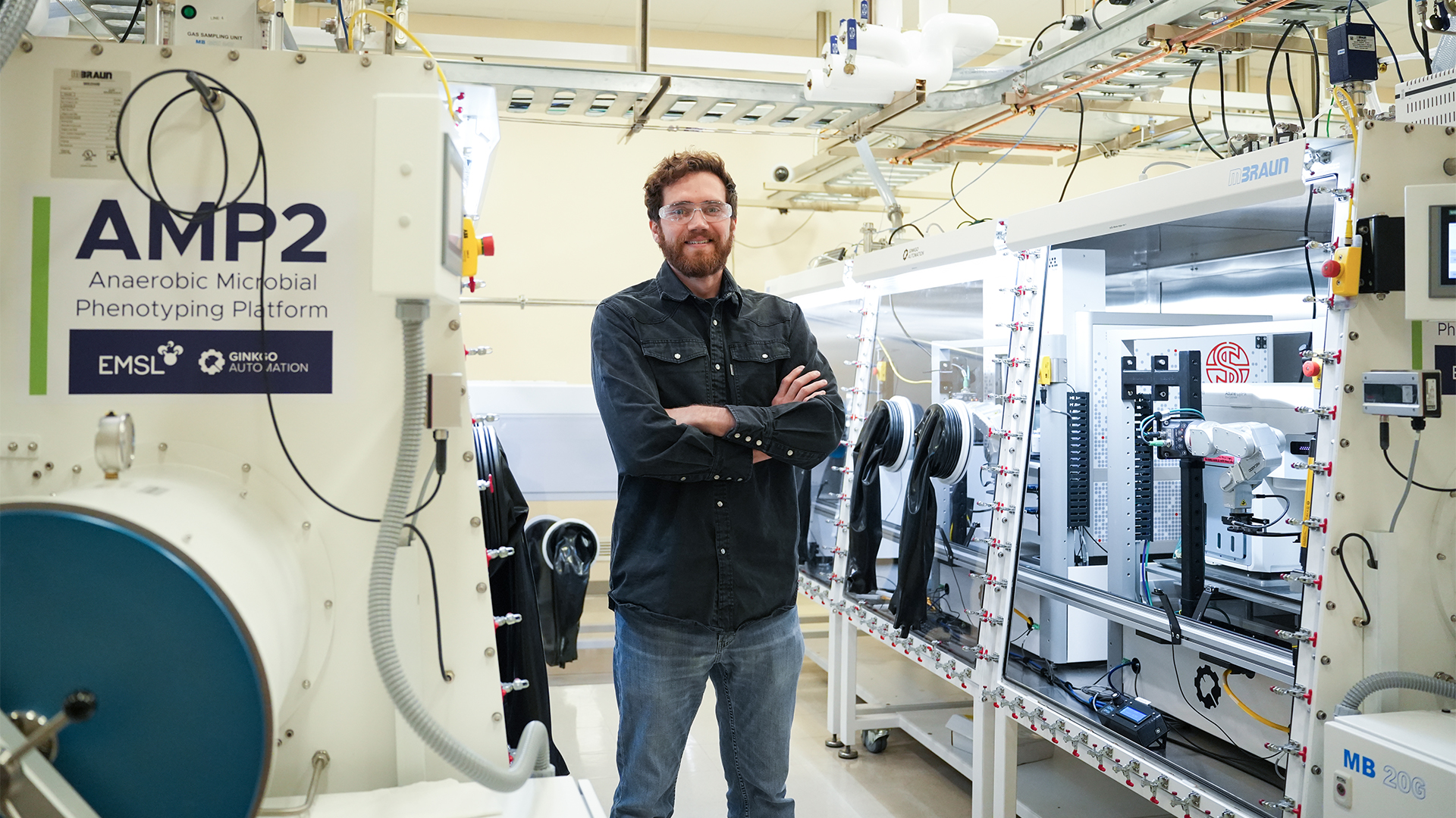 Photo of researcher Luke Fisher standing in the AMP2 lab.