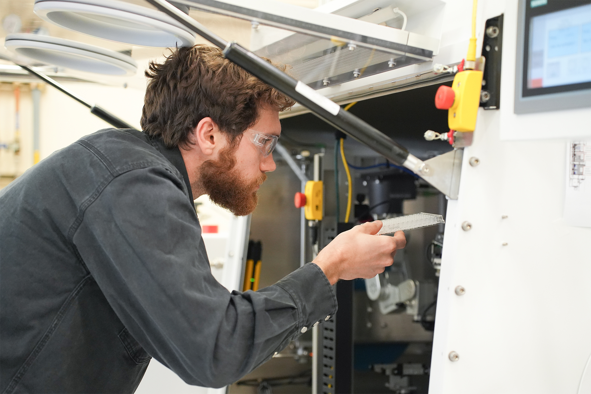Photo of researcher Luke Fisher working with AMP2 equipment.