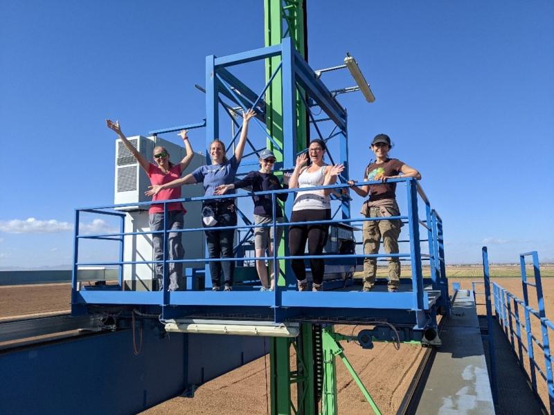 photo of five people on raised platform