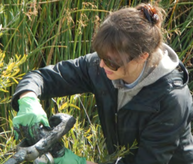 photo of owman sitting in tall grass