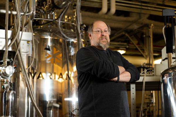 Andrew Lipton stands in front of NMR instrumentation