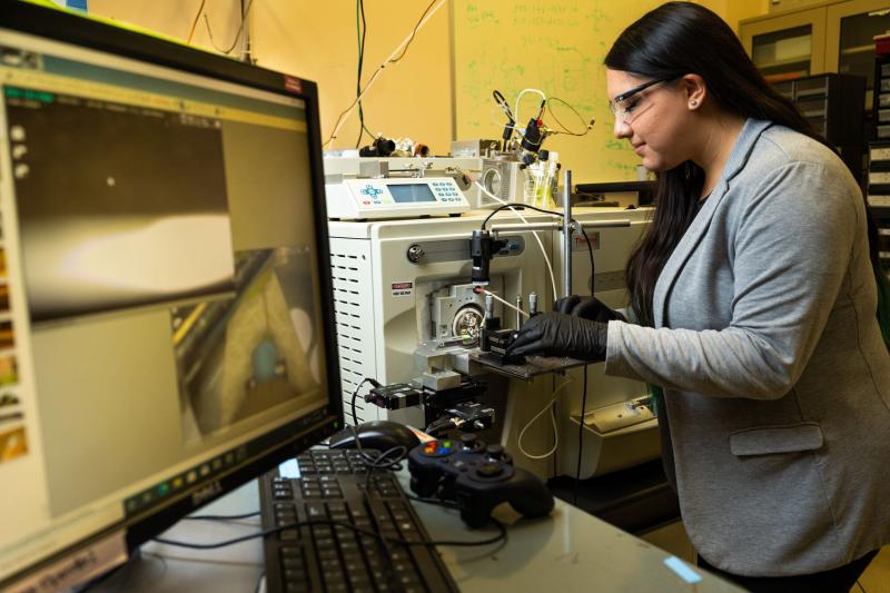 Researcher Mickey Rogers loads sample into EMSL instrument NanoDESI