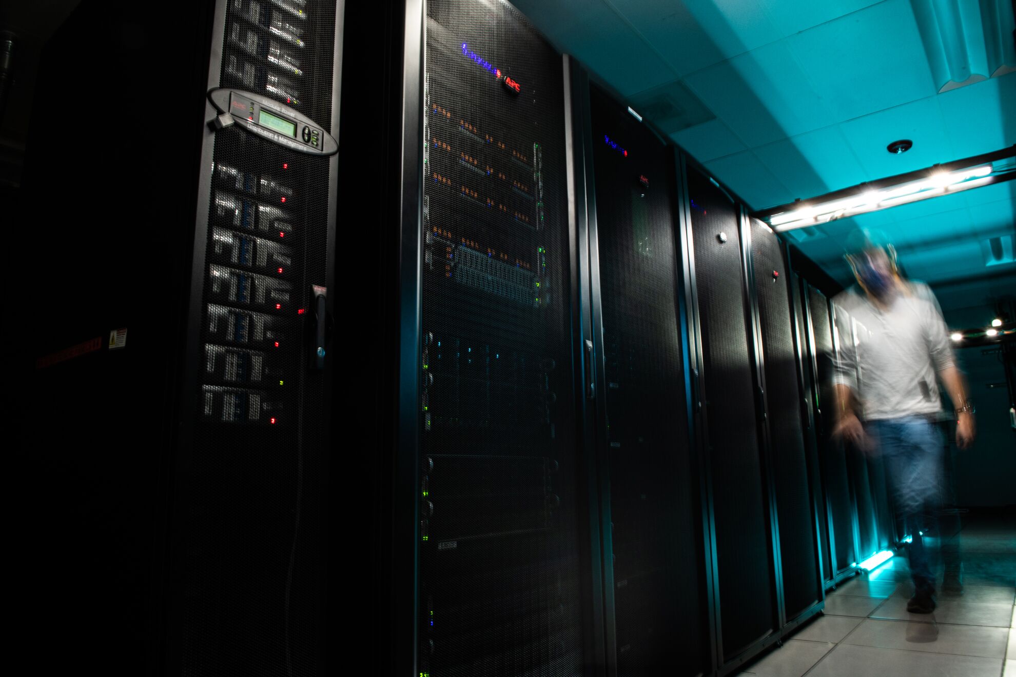 Person walks next to Tahoma computing cluster