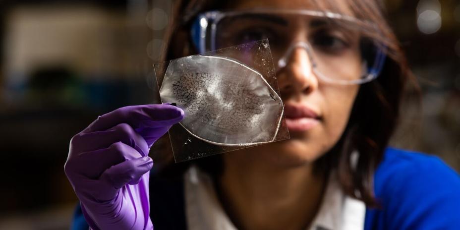 Arunima Bhattacharjee holds epoxy microfluidic device