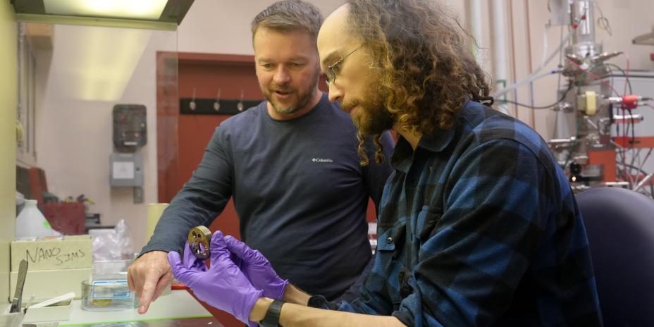 Scott Sugden and Jeremy Bougoure work with a sample.