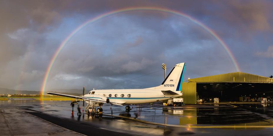 airplane under a rainbow