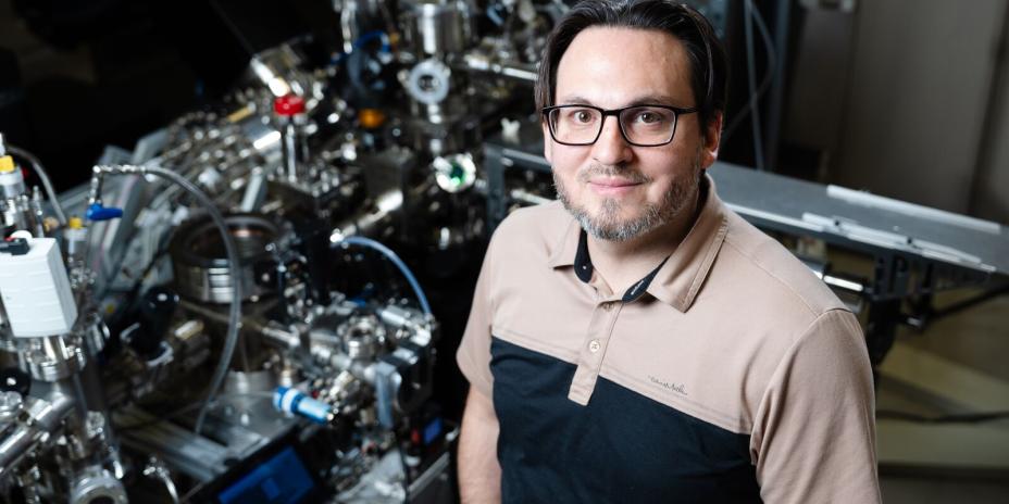 Daniel Perea stands in front of the atom probe tomography instrument at the Environmental Molecular Sciences Laboratory