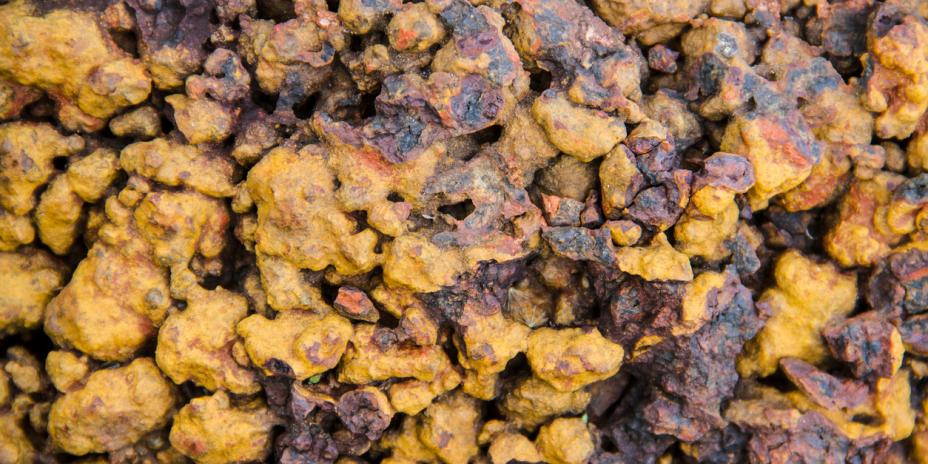 Photo of a pile of laterite stone, which displays in yellow and brown tones