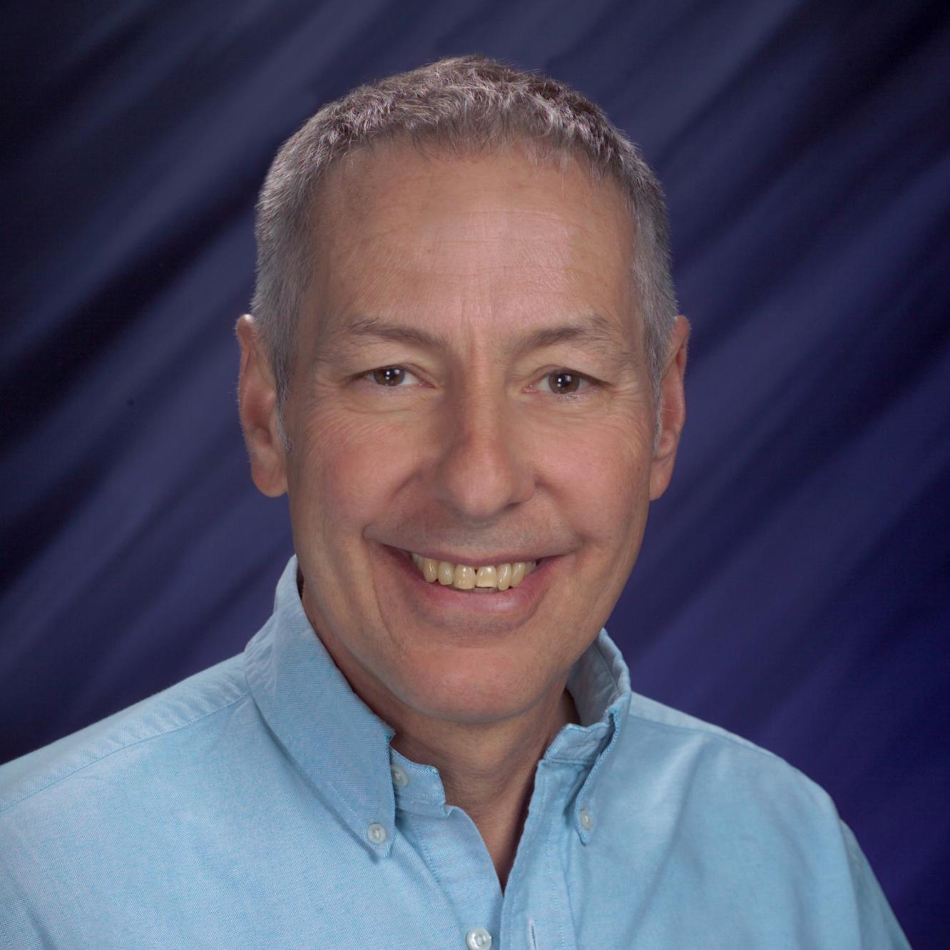 portrait of man in blue dress shirt