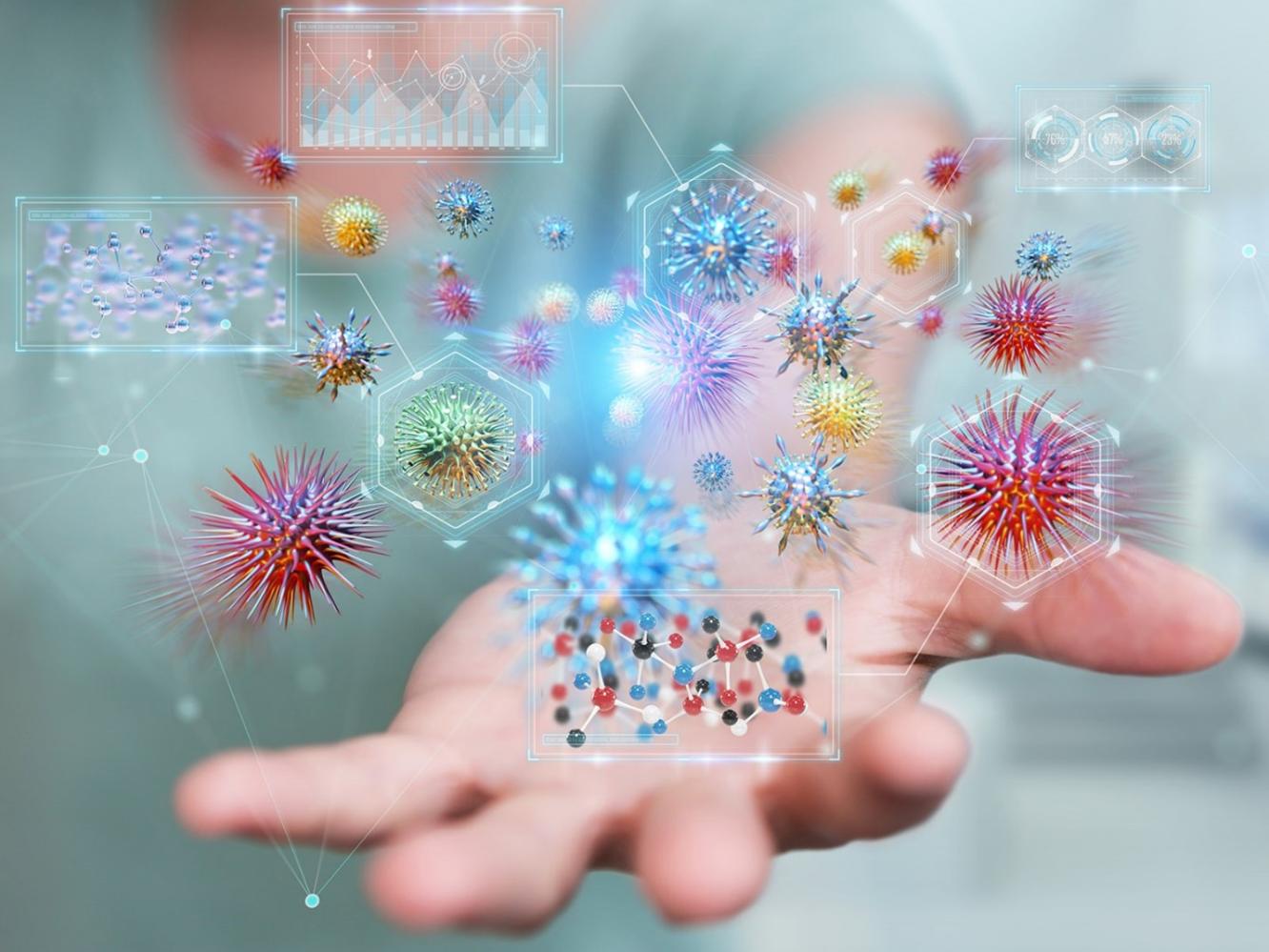 Image of an outstretched hand with tiny, spiky, multicolored objects hovering overhead. The National Microbiome Data Collaborative supports multi-omics data.