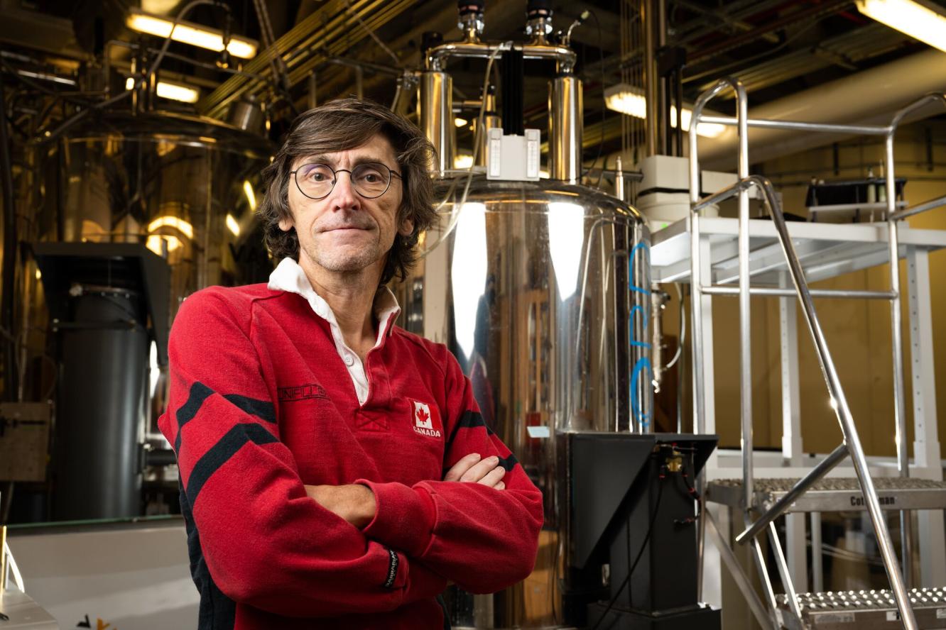 Garry Buchko stands in front of the Hood nuclear magnetic spectrometer.