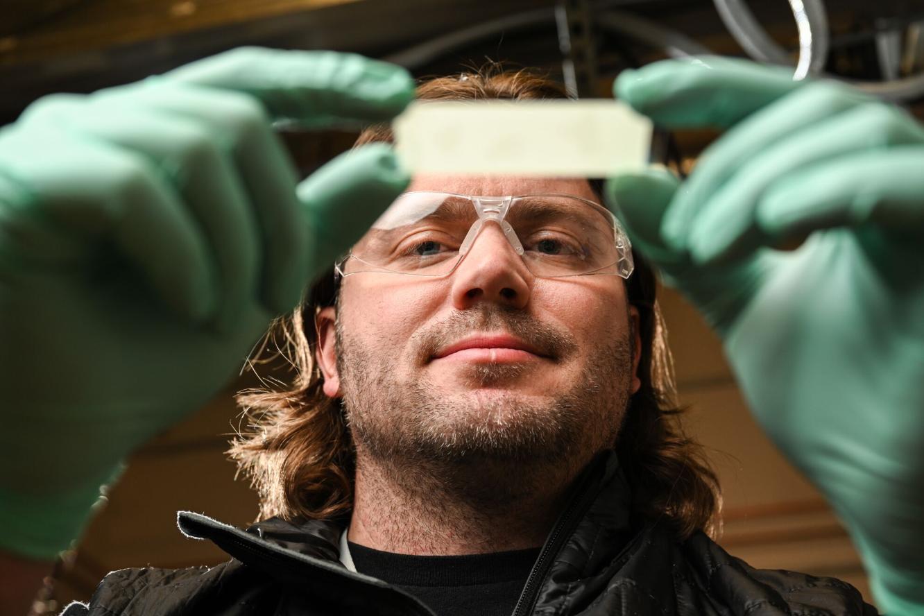 Chris Anderton holds sample