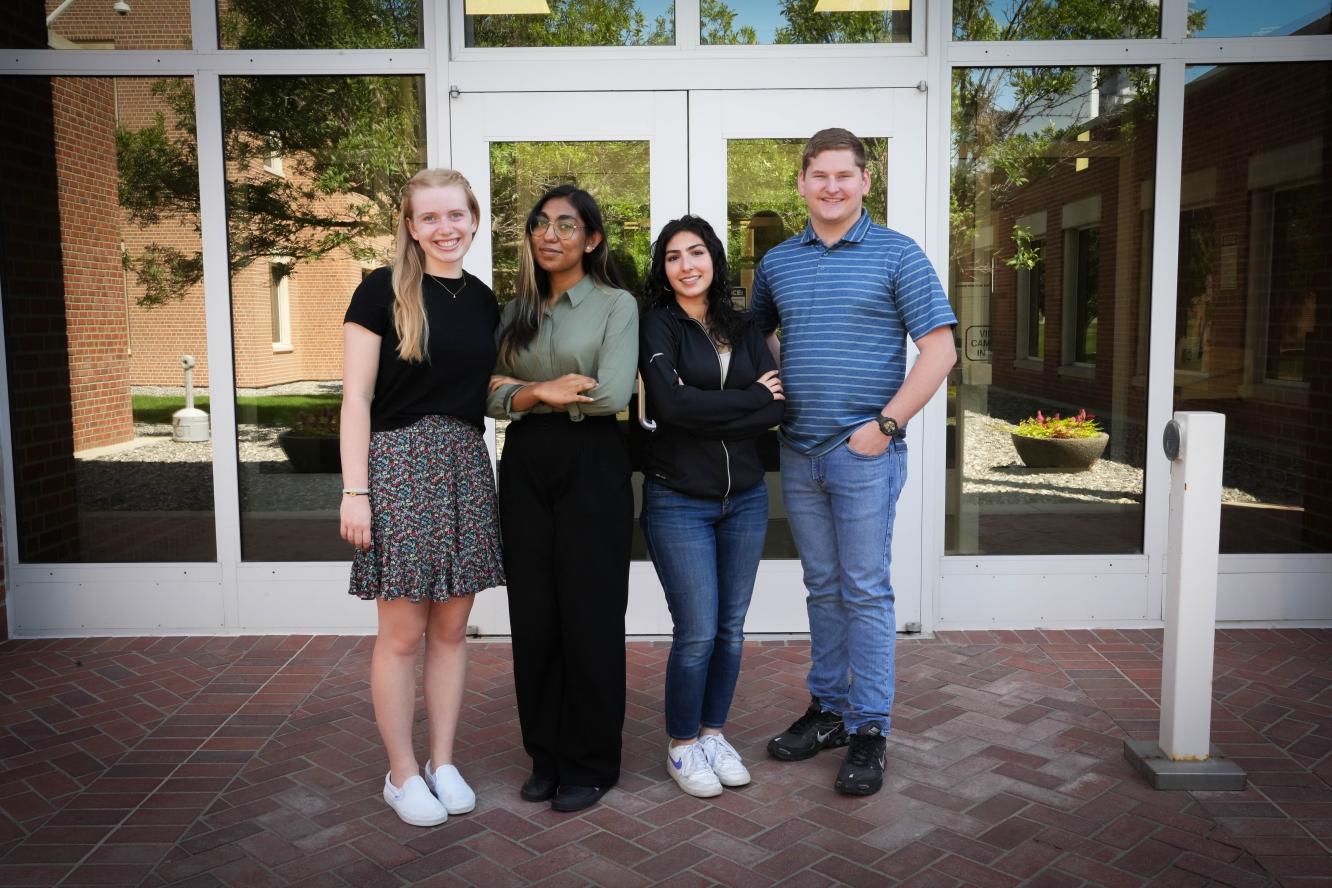 Kate Eddy, Oyshi Taluker, Yasamin Alazawi, and John Lindquist stand in front of the Environmental Molecular Sciences Laboratory