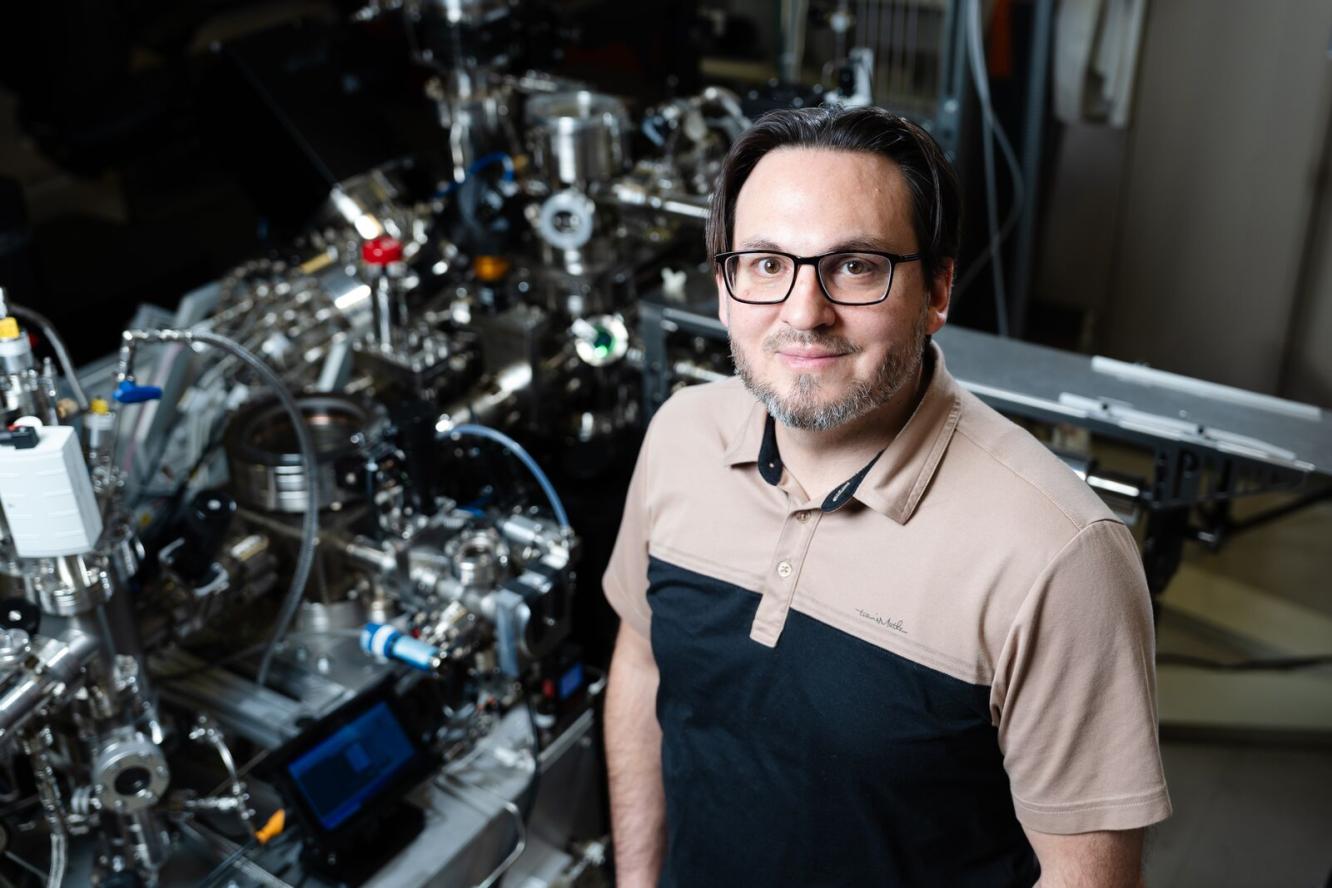 Daniel Perea stands in front of the atom probe tomography instrument at the Environmental Molecular Sciences Laboratory