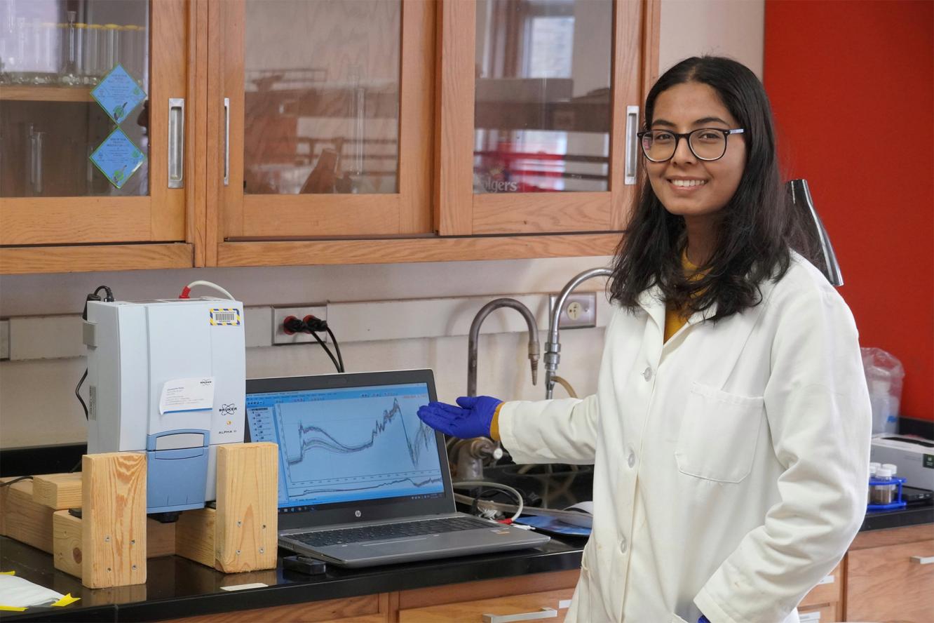 Photo of researcher Soni Ghimire in a laboratory setting, smiling at the camera.