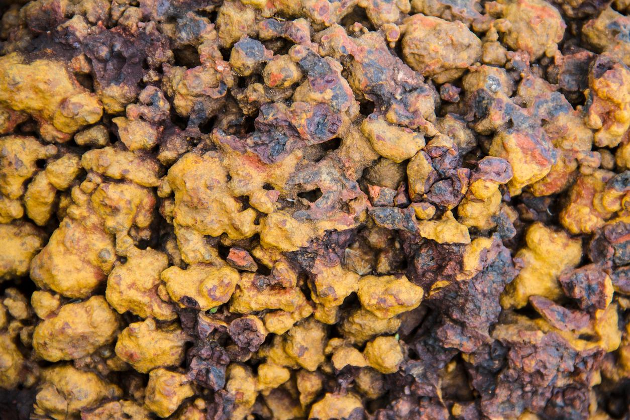 Photo of a pile of laterite stone, which displays in yellow and brown tones