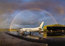 airplane under a rainbow