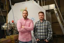 Kevin Zemaitis and Will Kew stand in front my EMSL's FTICR mass spectrometer.