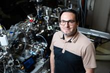 Daniel Perea stands in front of the atom probe tomography instrument at the Environmental Molecular Sciences Laboratory
