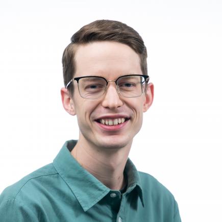 photo of man in polo shirt and glasses